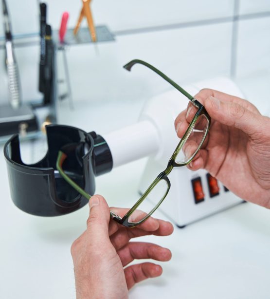 Optician fitting new prescription lenses